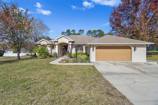 ranch-style home featuring a garage and a front lawn