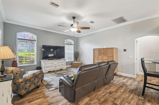 living room with ceiling fan, ornamental molding, and hardwood / wood-style flooring