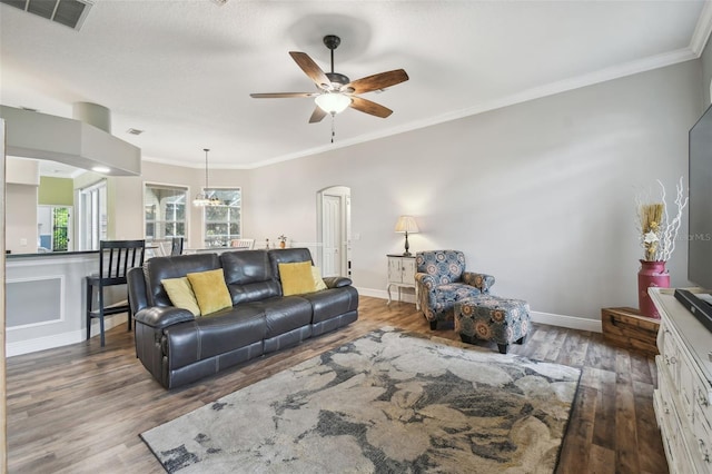 living room with ceiling fan, dark hardwood / wood-style flooring, and crown molding