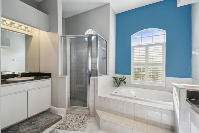 bathroom featuring vanity and separate shower and tub