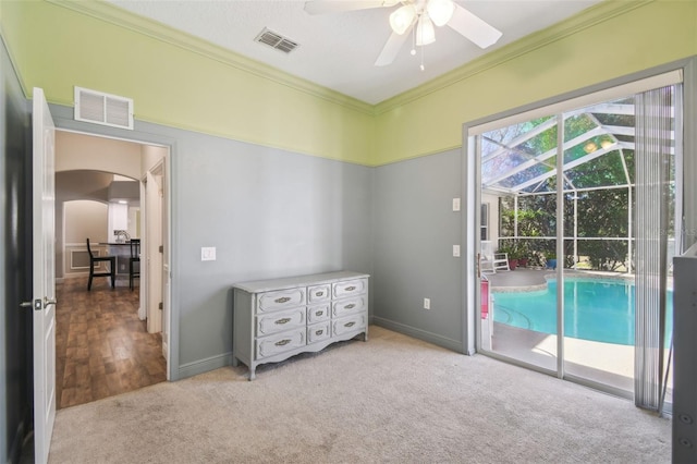 interior space with ceiling fan, ornamental molding, and access to outside