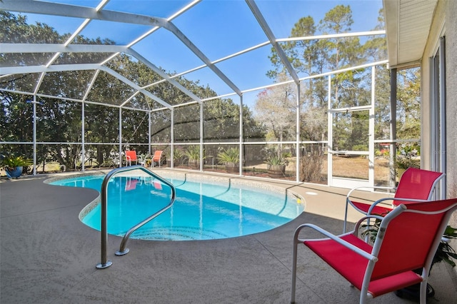 view of swimming pool with a patio area and a lanai