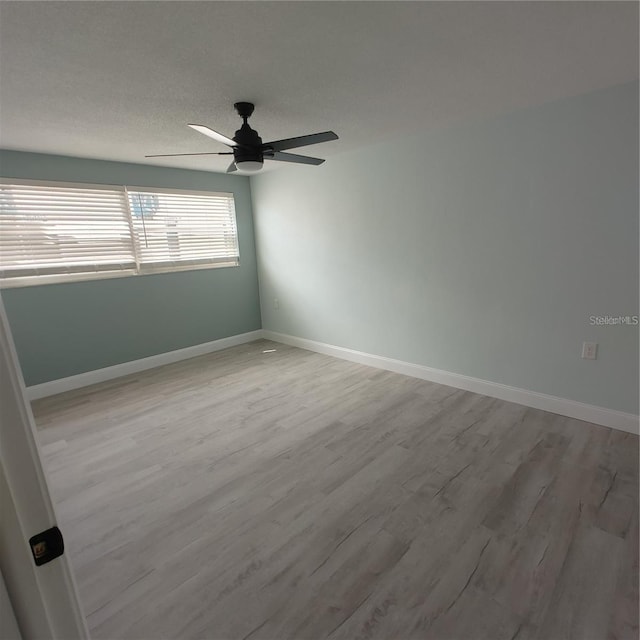 spare room with ceiling fan and light hardwood / wood-style floors