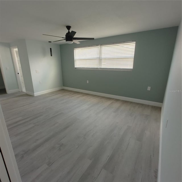 unfurnished room with ceiling fan and light wood-type flooring