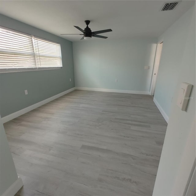 unfurnished room with ceiling fan and light hardwood / wood-style flooring