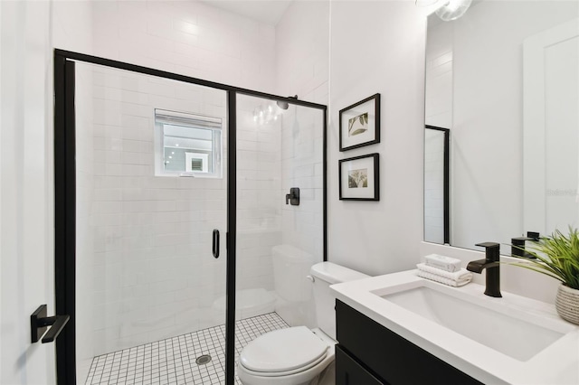 bathroom with vanity, toilet, and an enclosed shower