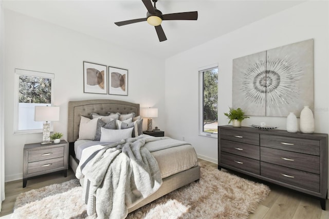 bedroom featuring ceiling fan and light hardwood / wood-style flooring