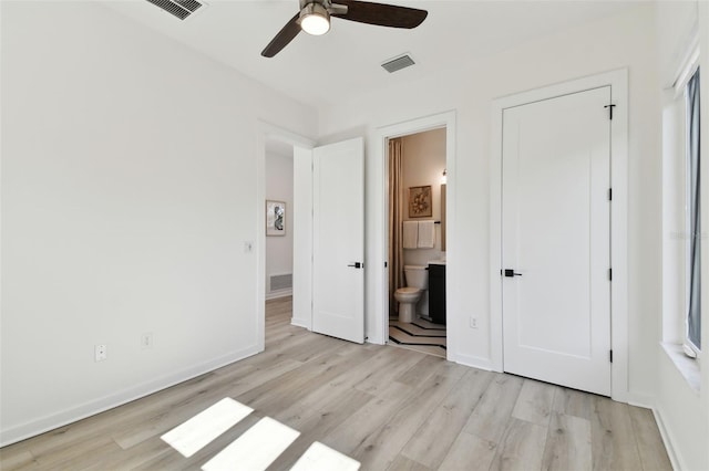 unfurnished bedroom featuring ceiling fan, connected bathroom, and light hardwood / wood-style floors