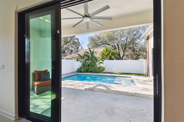 view of swimming pool featuring a patio and ceiling fan