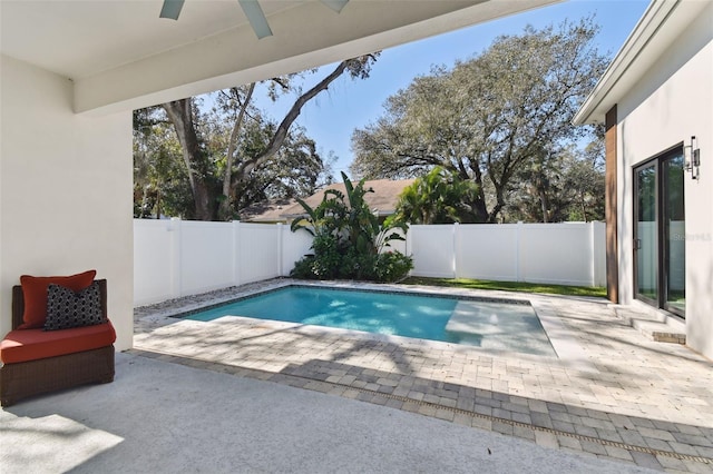 view of swimming pool with ceiling fan and a patio