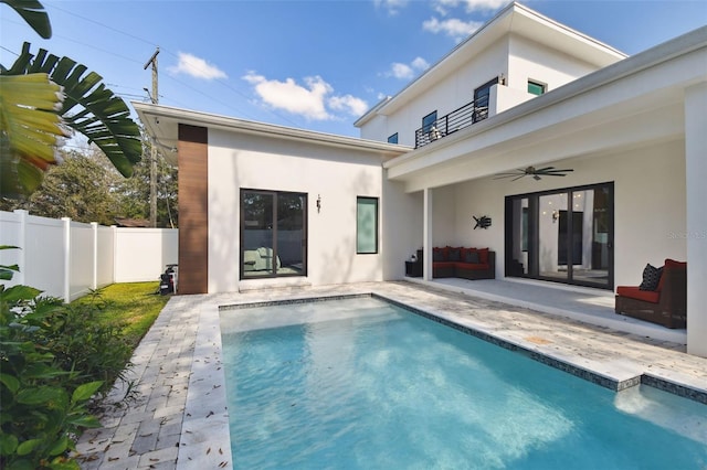 rear view of property with a fenced in pool, a patio area, a balcony, and ceiling fan