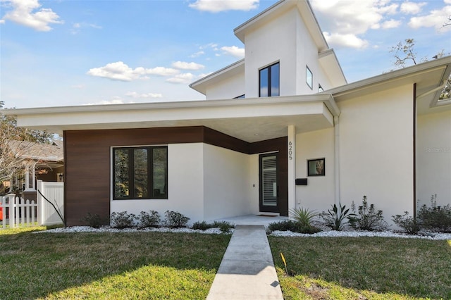 view of exterior entry with a yard