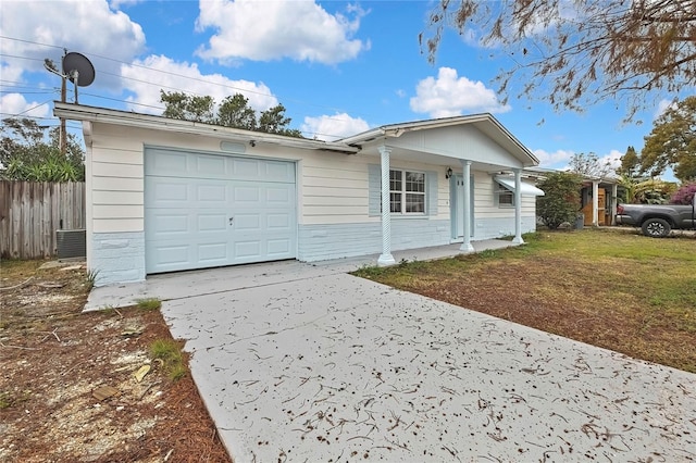 ranch-style home with a garage and a front lawn