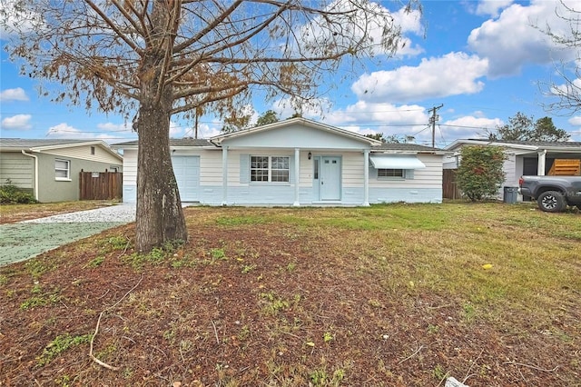 single story home featuring a garage and a front yard