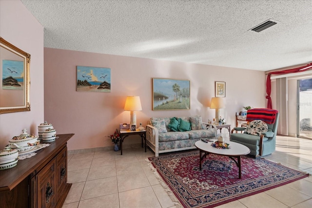 living room featuring light tile patterned floors and a textured ceiling