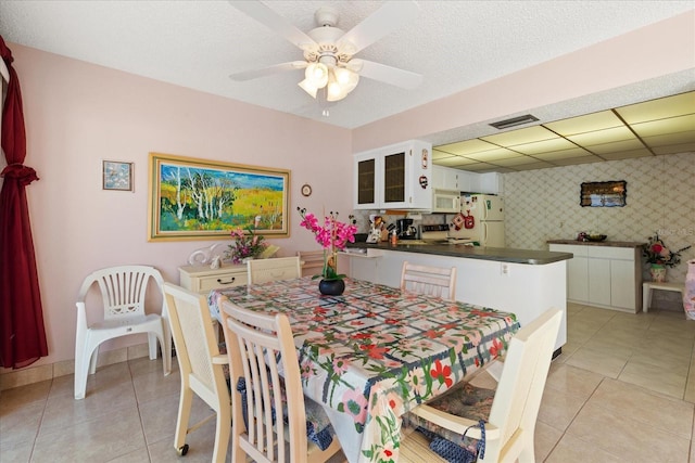 tiled dining area with ceiling fan