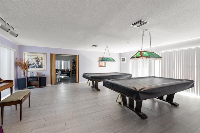 rec room with track lighting, billiards, and a textured ceiling