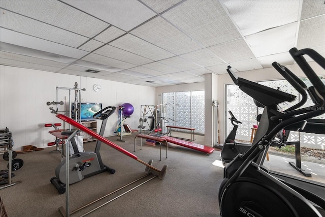 gym with a paneled ceiling