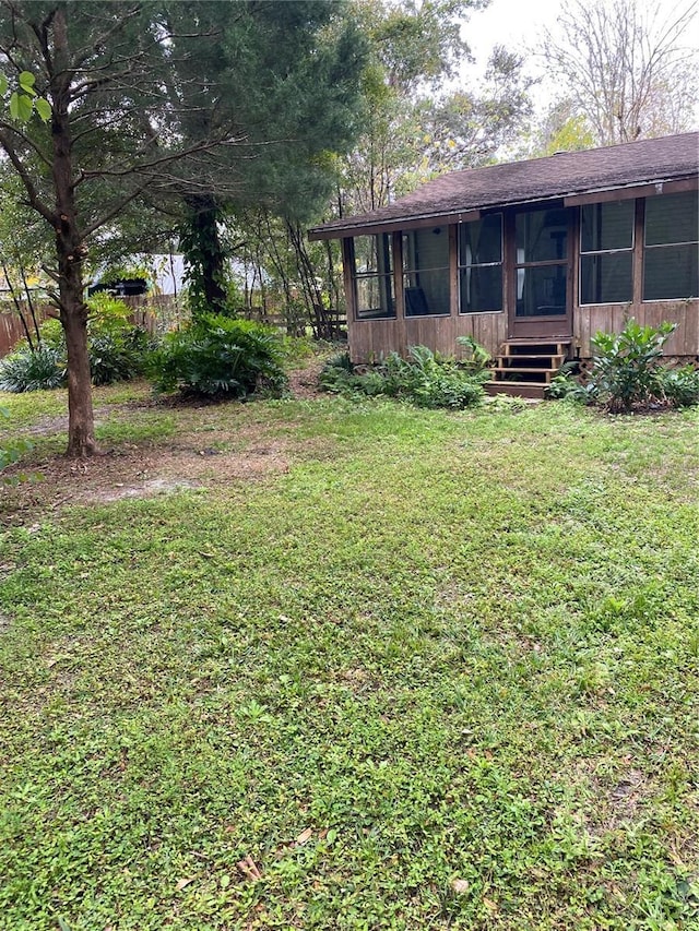 view of yard featuring a sunroom