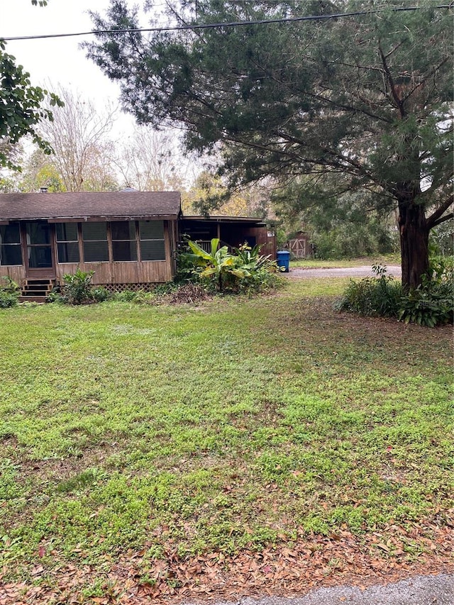 view of yard with a sunroom