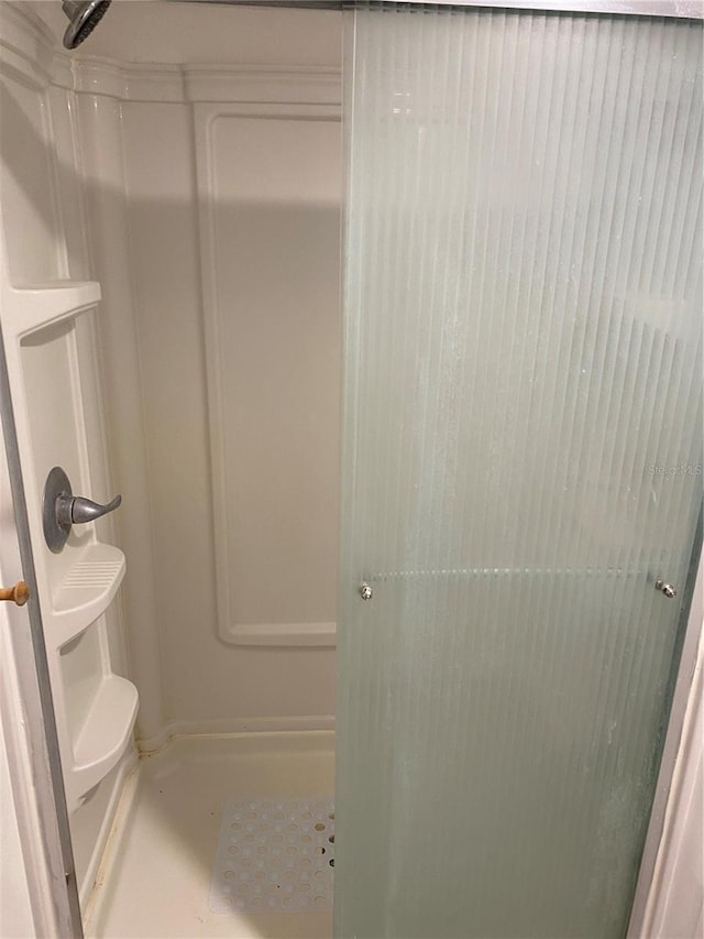 bathroom featuring toilet and walk in shower