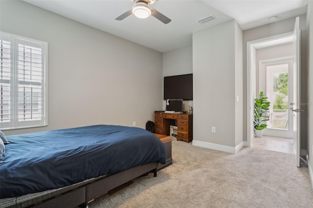 bedroom featuring light carpet and ceiling fan