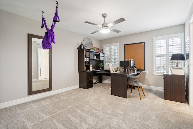 carpeted office featuring ceiling fan