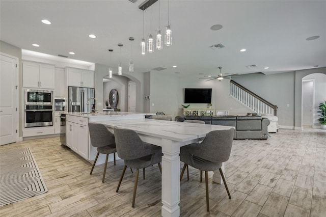 dining room featuring ceiling fan and sink