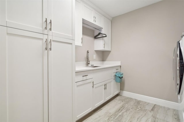 kitchen featuring white cabinets and sink