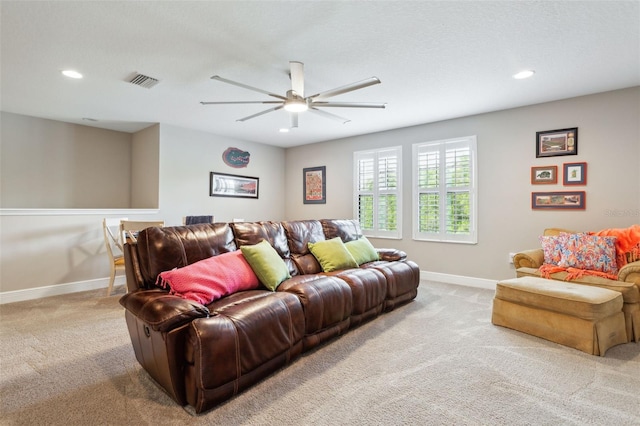 living room featuring light carpet and ceiling fan