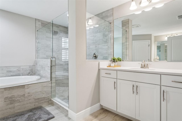 bathroom featuring plus walk in shower and vanity