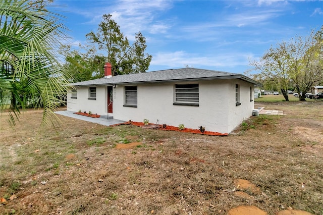 back of property featuring a yard