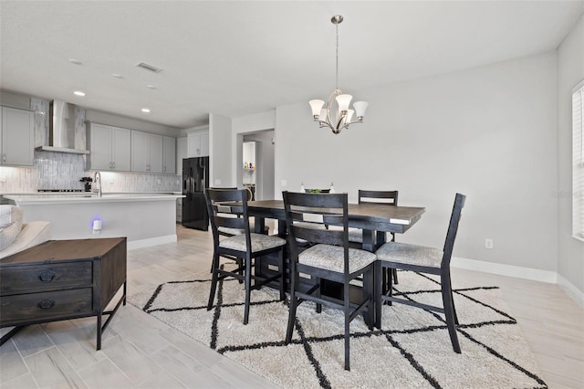 dining space with an inviting chandelier and light wood-type flooring