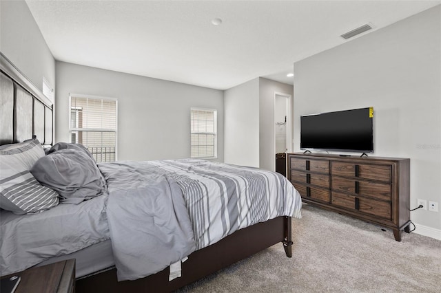 carpeted bedroom featuring multiple windows