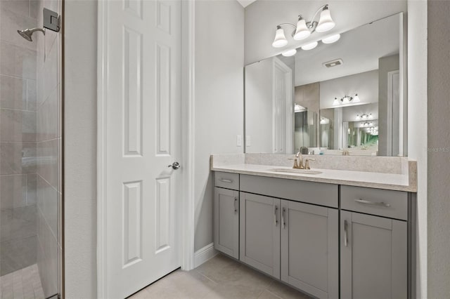 bathroom featuring an enclosed shower, tile patterned floors, and vanity