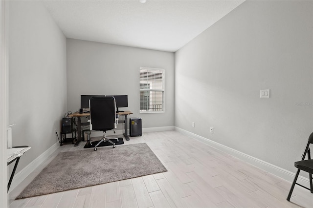 office with light hardwood / wood-style floors