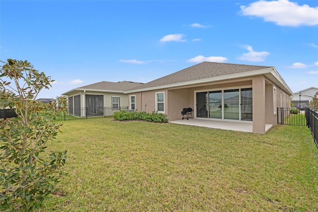 rear view of house featuring a patio area and a lawn