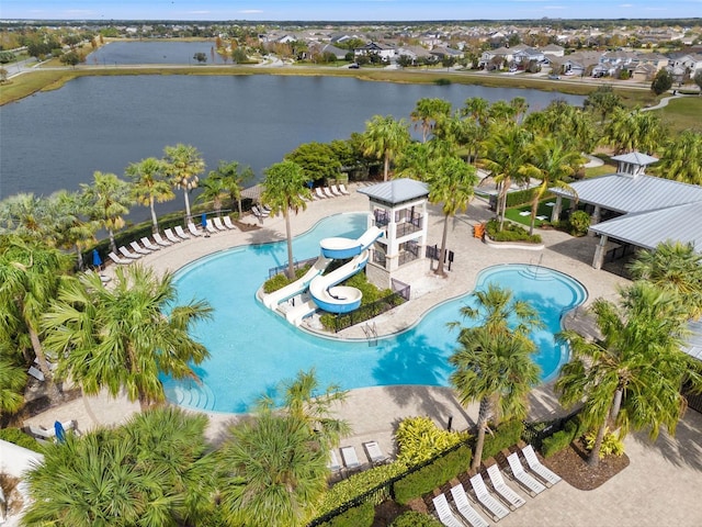 view of swimming pool with a patio area, a water view, and a water slide