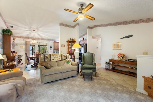 tiled living room with ceiling fan