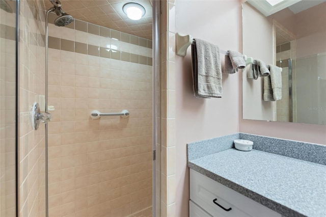 bathroom featuring vanity and a shower with shower door