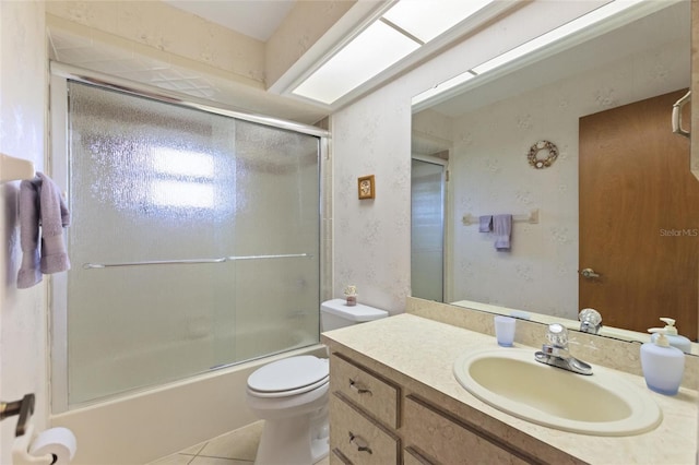 full bathroom featuring vanity, tile patterned floors, enclosed tub / shower combo, and toilet