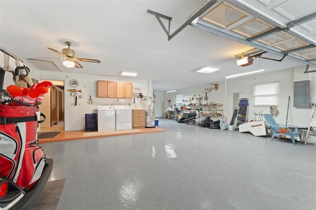 garage featuring a garage door opener, ceiling fan, electric panel, and independent washer and dryer