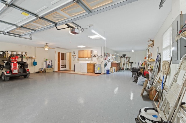 garage with a garage door opener and washer and dryer