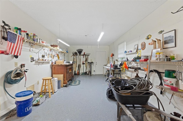 miscellaneous room featuring a textured ceiling and a workshop area