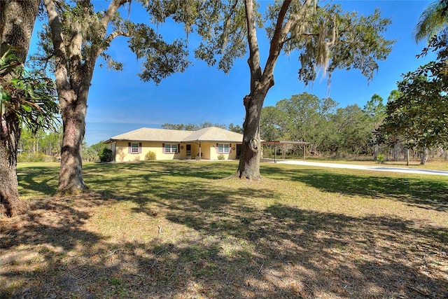 ranch-style house featuring a front yard and a carport