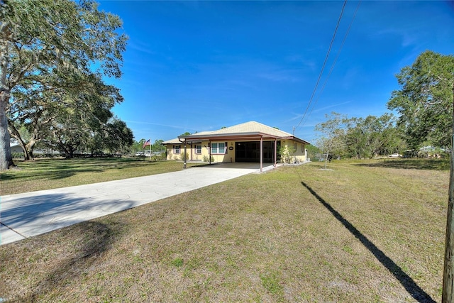 back of property with a carport and a yard