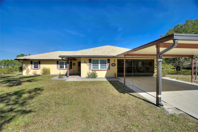 ranch-style home with a carport and a front lawn