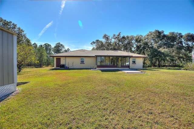 rear view of house with a yard, central AC unit, and a patio