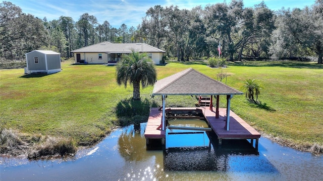 view of dock featuring a yard, a gazebo, and a water view