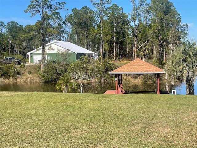 view of yard featuring a gazebo and a water view